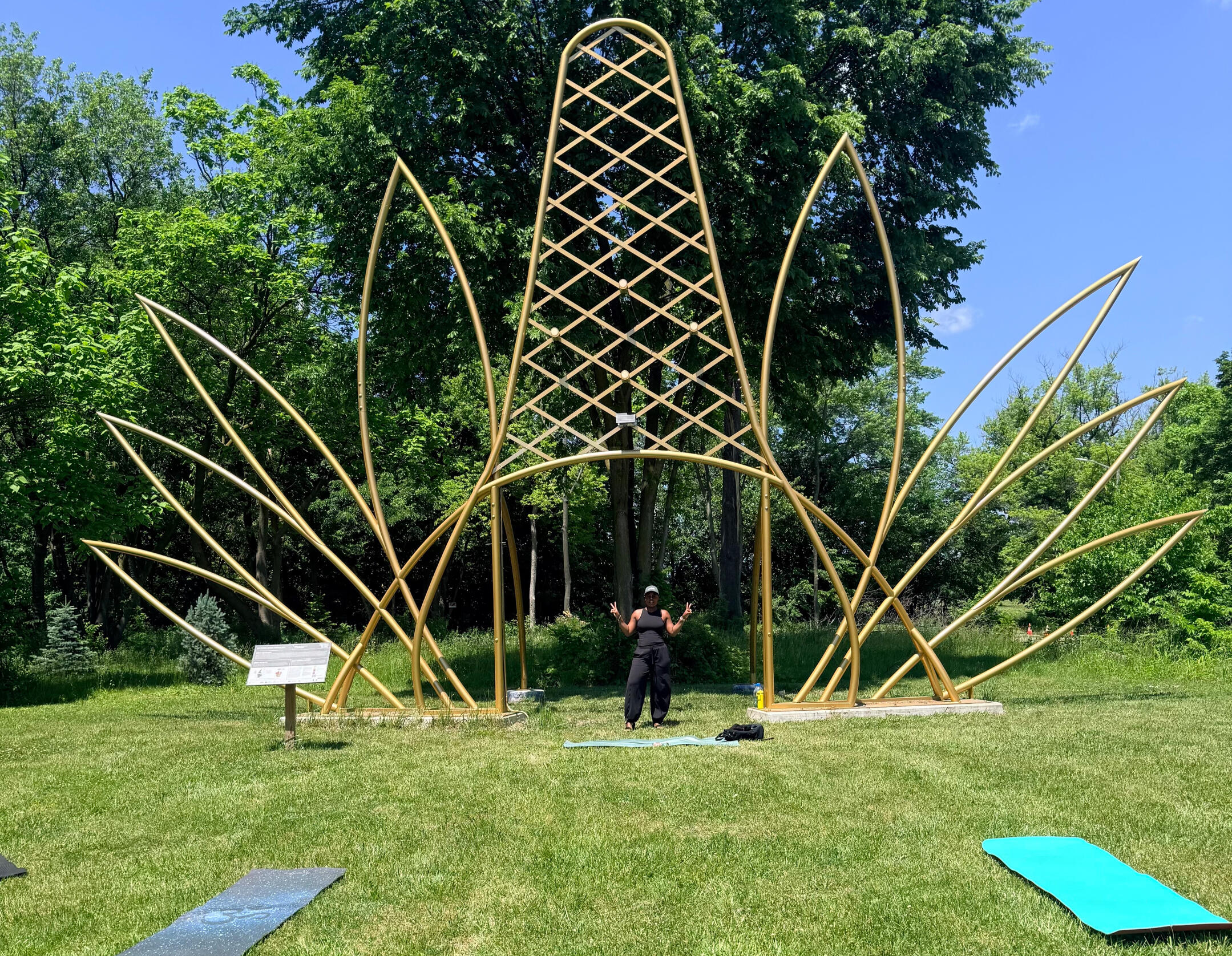 East Canfield Art Park woman standing under gold crown sculpture